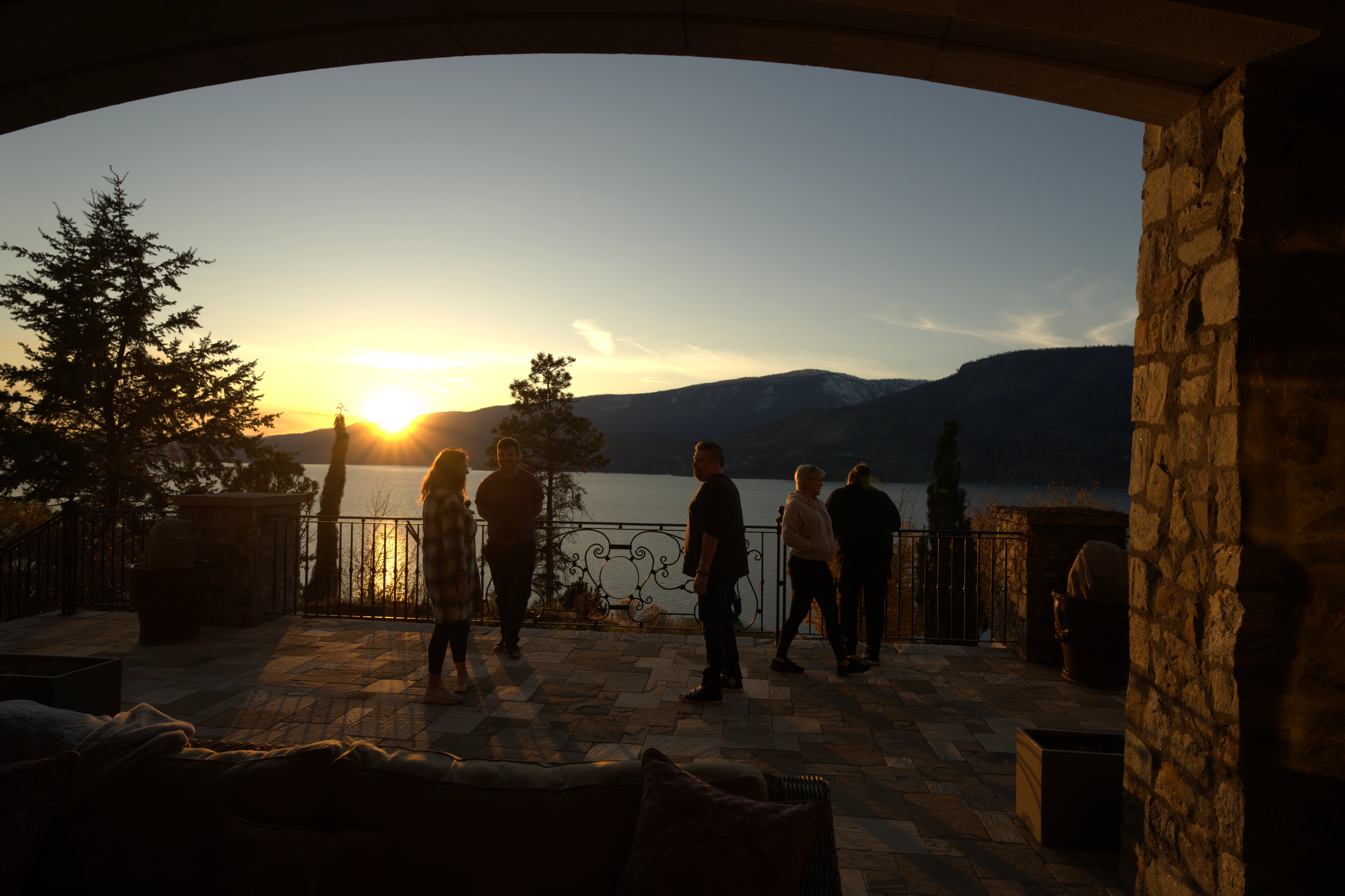 Family gathering at sunset on the terrace at Château Okanagan