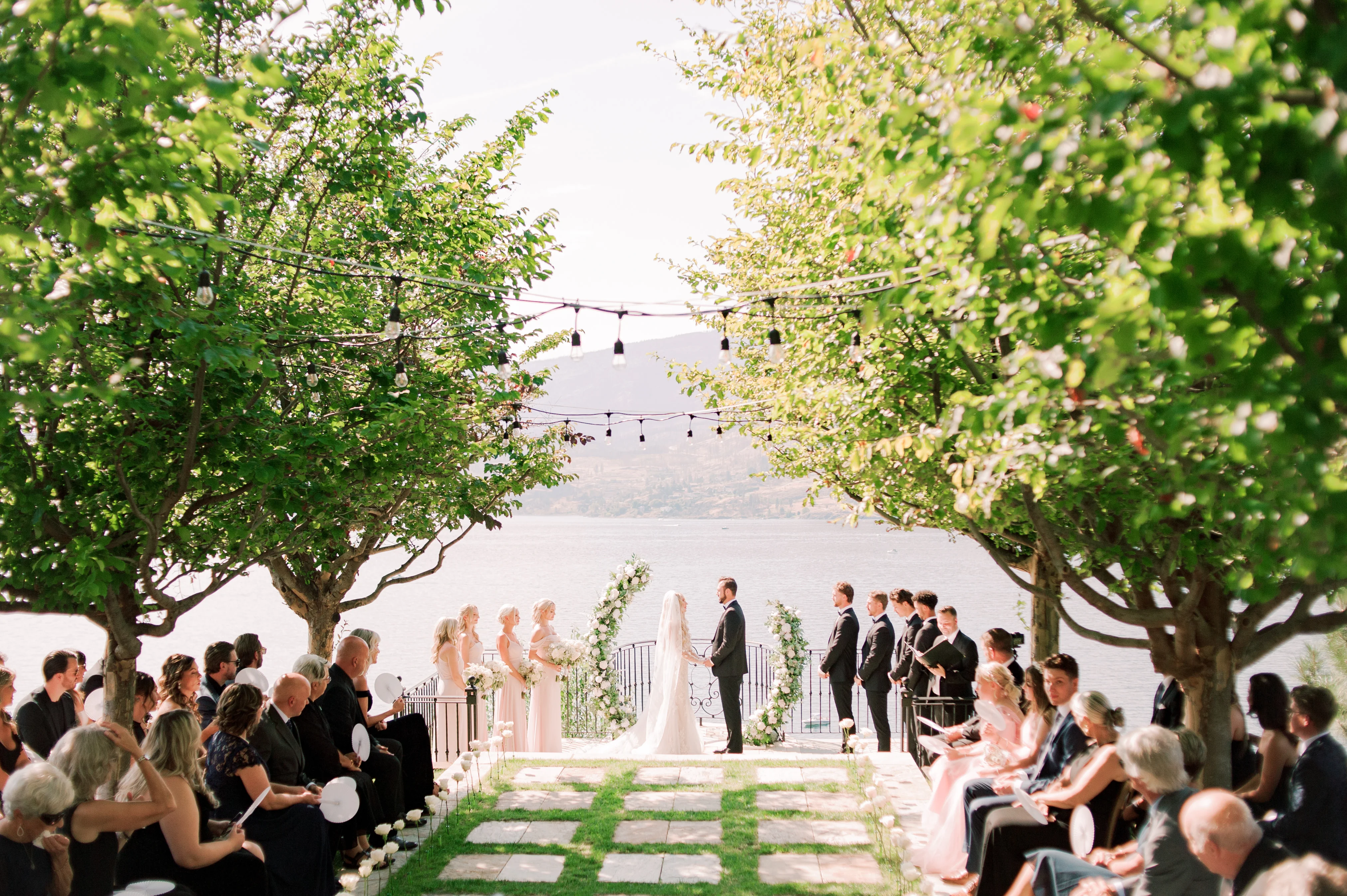 Outdoor wedding ceremony at Château Okanagan with lake views